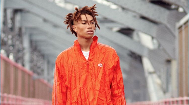 Embracing monochromatic style, Seth Hill wears a Sunspel tee with a windbreaker, pants, and sneakers from Adidas Originals by Alexander Wang.