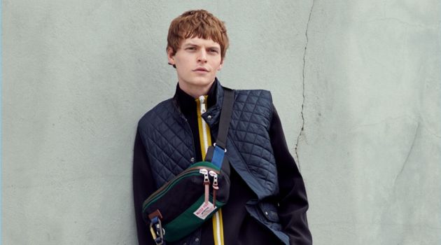 The New Rugged: John Hein Embraces Weekend Style from East Dane On the move, John Hein wears an Our Legacy jacket, Belstaff quilted vest, and Carhartt WIP cargo pants. His look is complete with Veja SDU sneakers and a Master-Piece Link waist bag.