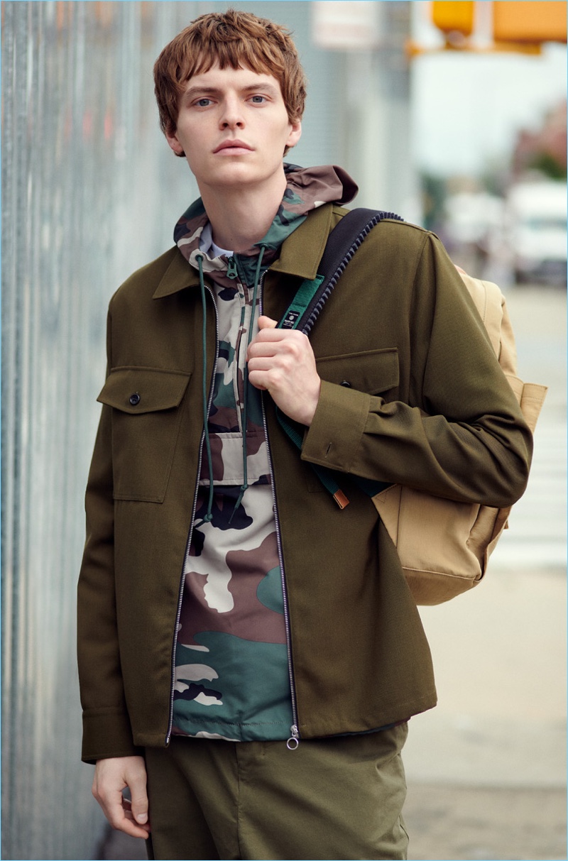 John Hein wears AMI pants and a zipper jacket. He also sports an Obey anorak and Master-Piece Link backpack.