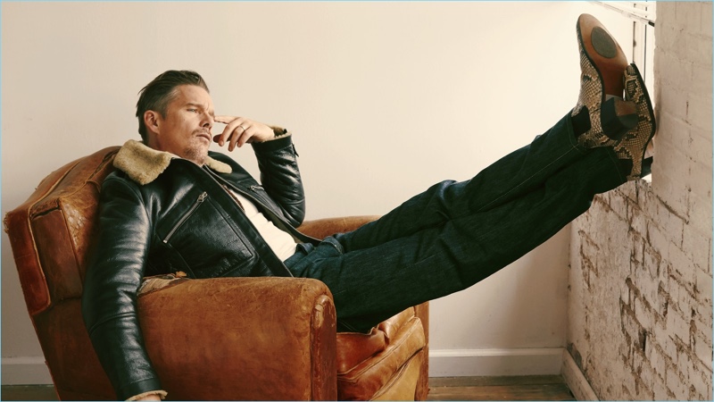 Ethan Hawke wears a leather Tom Ford jacket, Ermenegildo Zegna Couture turtleneck, and Levi's Vintage Clothing jeans. He sports Tom Ford boots as well.