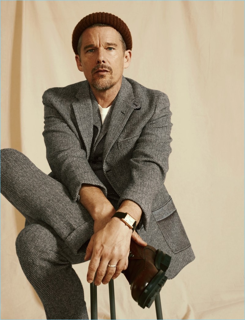 Connecting with GQ, Ethan Hawke wears a coat, vest, and pants by Ralph Lauren. A Levi's Vintage Clothing t-shirt, Dsquared2 boots, BOSS beanie, and Cartier watch complete his look.