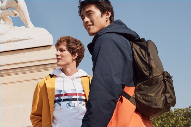 Exploring Paris, Felix Gesnouin and Zhao Lei link up with H&M. Zhao sports the label's foldable backpack.