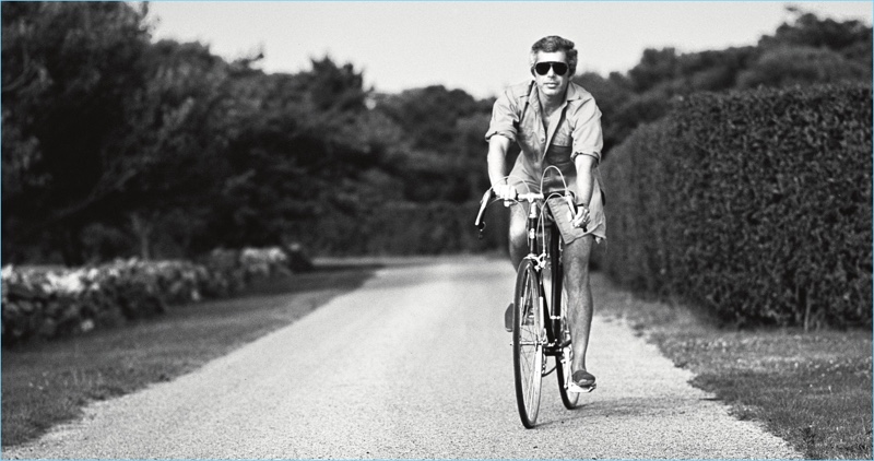 A picture of a younger Ralph Lauren riding a bike.