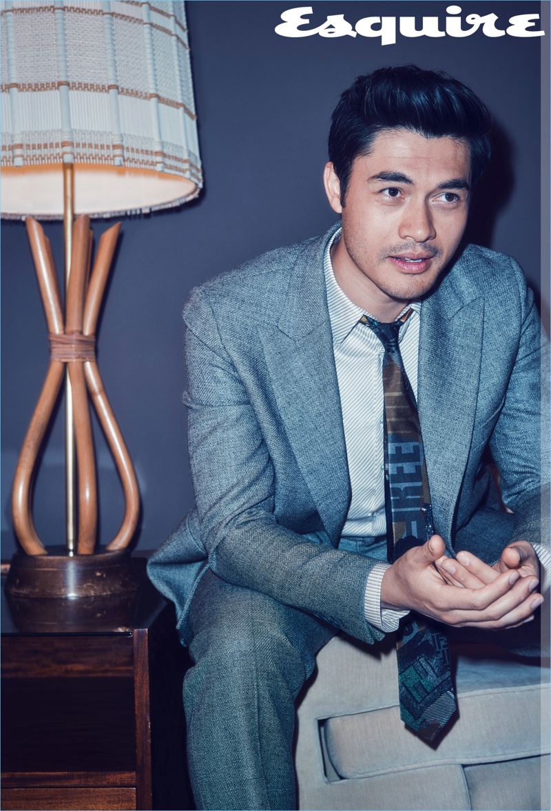 Actor Henry Golding sports a shirt, suit, and tie by Fendi.