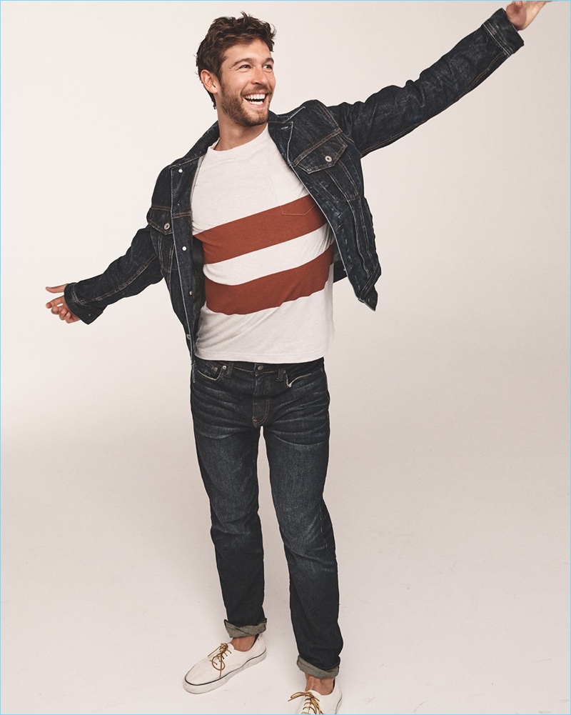 Josh Upshaw models a J.Crew classic denim jacket, double stripe t-shirt, and 770 straight-fit jeans with Vans sneakers.