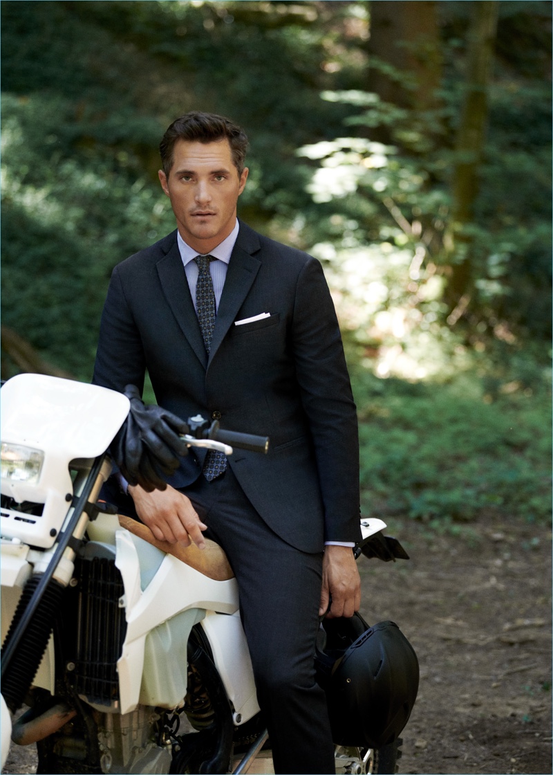 British model Ollie Edwards wears Mango Man's travel suit in navy check.