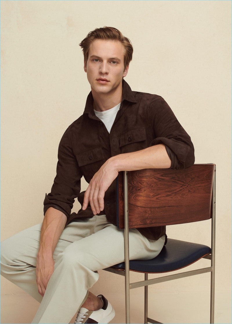 Model Jules Raynal dons a suede overshirt and pleated pants from Mango Man.