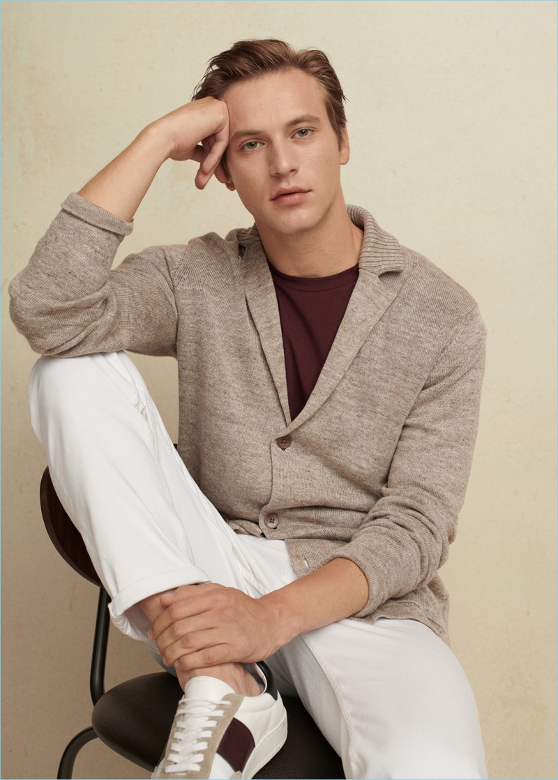 A smart vision, Jules Raynal sports a Mango Man cardigan, tee, pants, and sneakers.