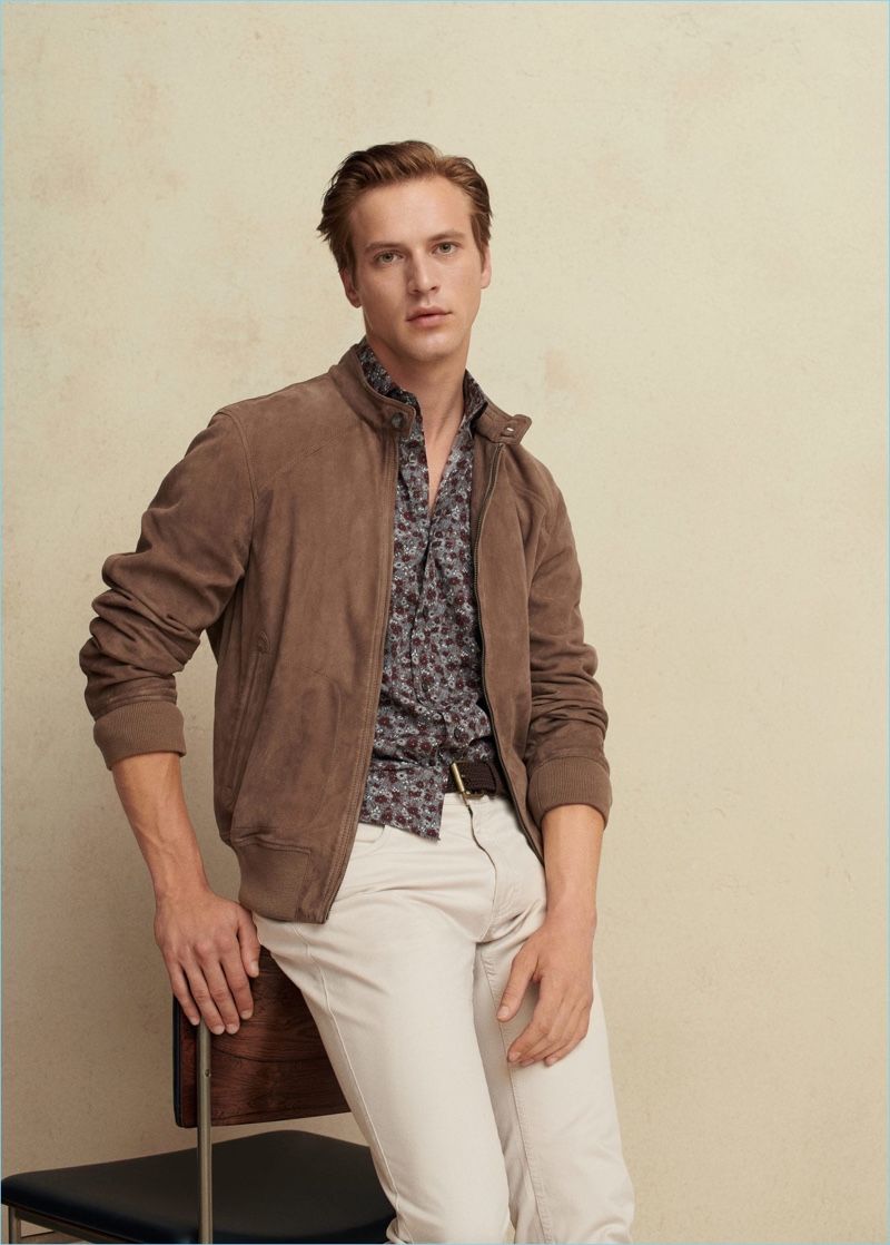 French model Jules Raynal dons a brown suede bomber, printed shirts, and white jeans from Mango Man.