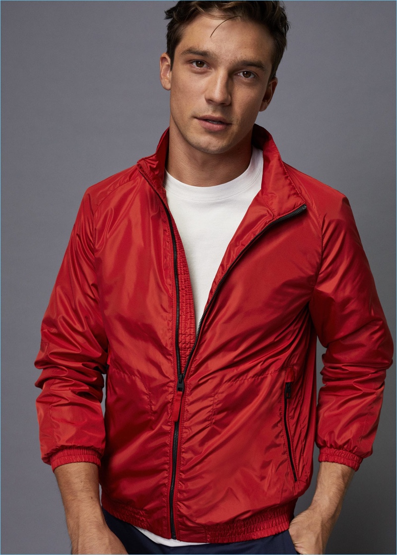 Going sporty, Alexis Petit dons a red windbreaker from Mango Man.