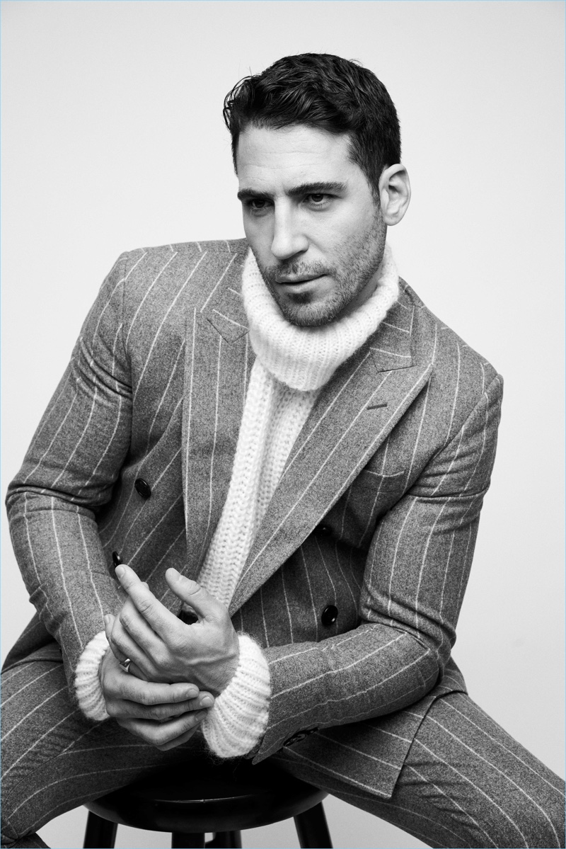 Miguel Angel Silvestre wears a pinstripe suit and turtleneck sweater by BOSS.