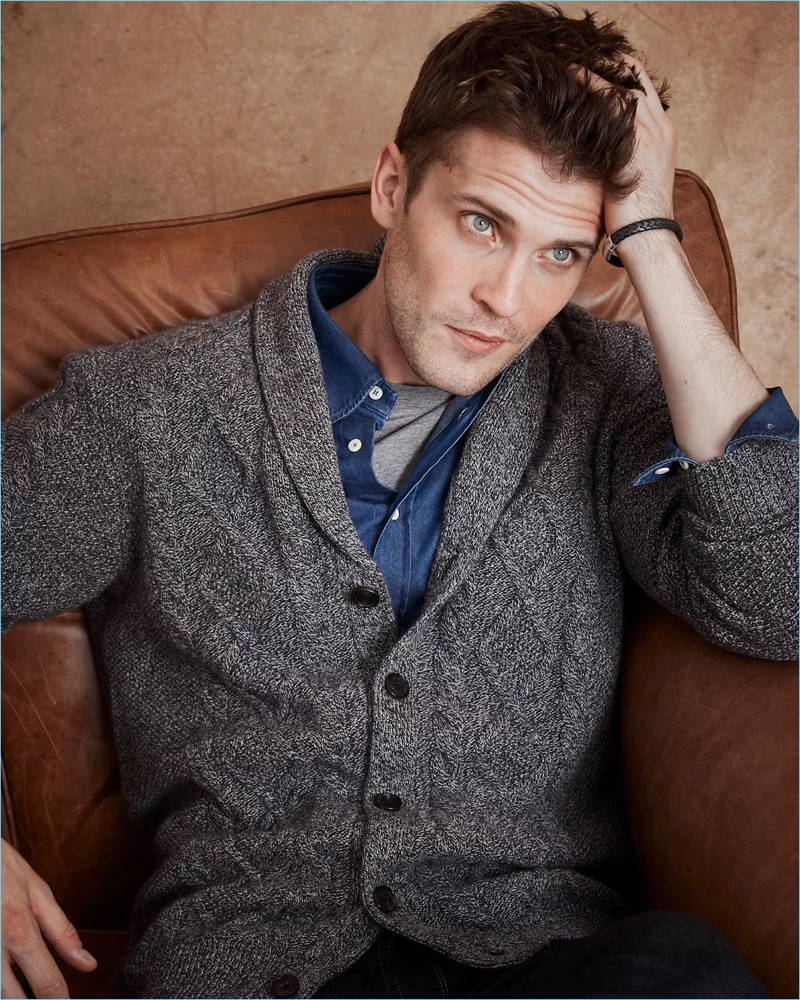 William Eustace dons a Neiman Marcus textured cable-knit shawl-collar cashmere cardigan in gray.