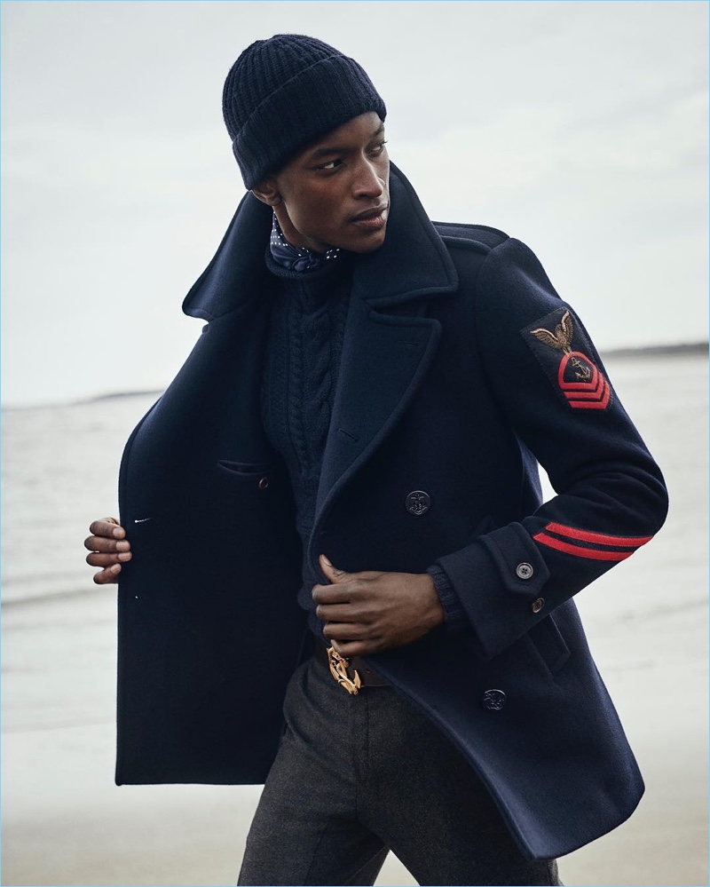 Model Oliver Kumbi dons a naval peacoat from Ralph Lauren Purple Label's fall-winter 2018 collection.