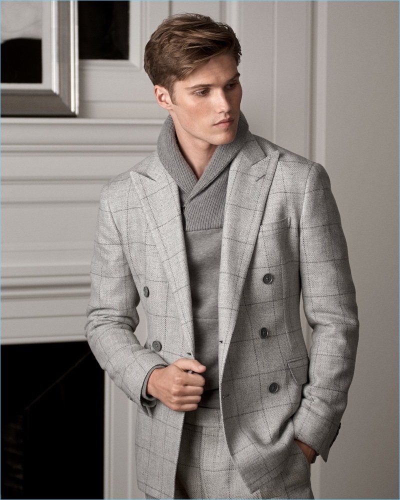 Embracing shades of grey, Nick Truelove dons a windowpane print suit with a shawl collar sweater from Ralph Lauren Purple Label.