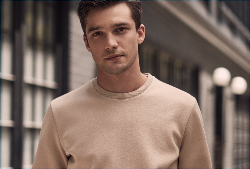 Sweater Weather: Alexis Petit dons a camel sweater from Reiss.