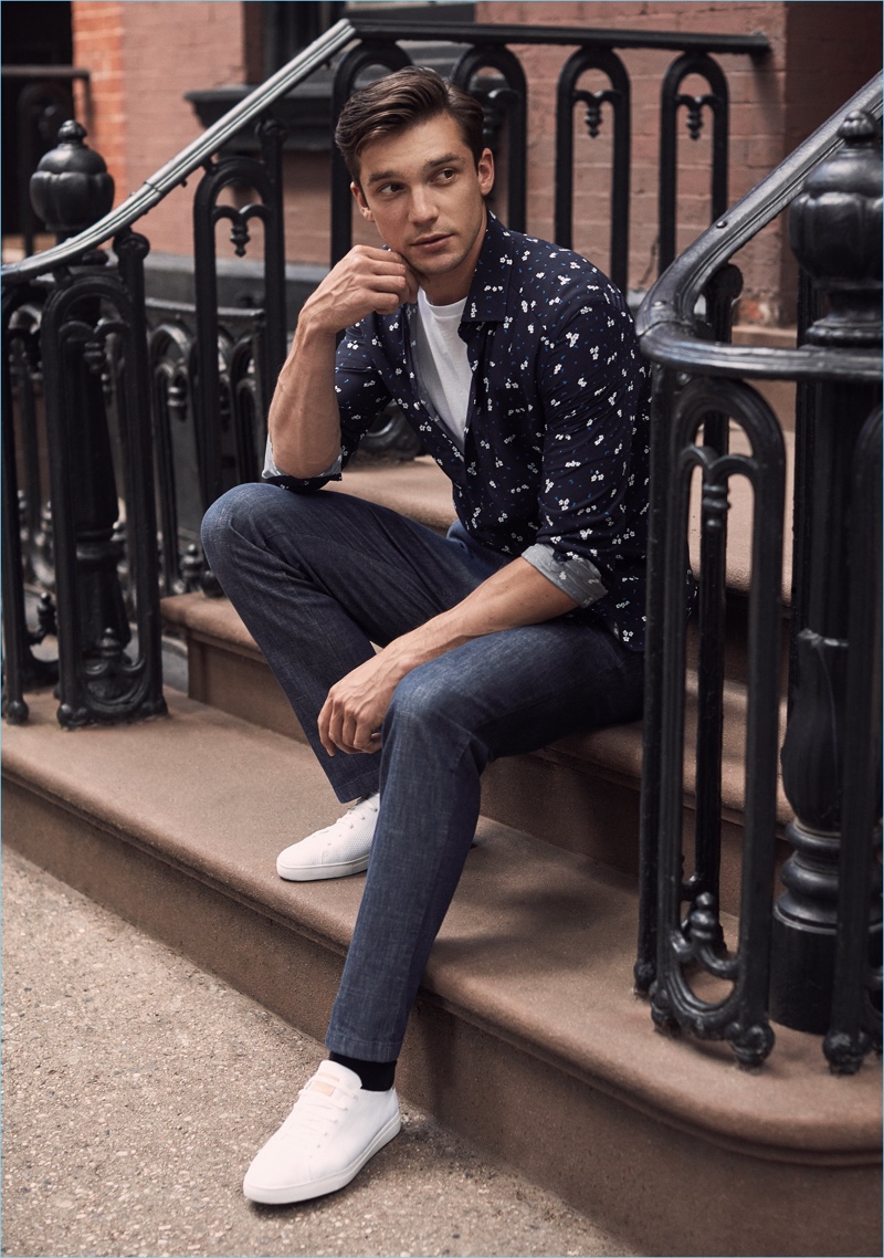 Fresh Prints: Alexis Petit wears a navy floral print shirt, tee, and slim-fit trousers from Reiss.
