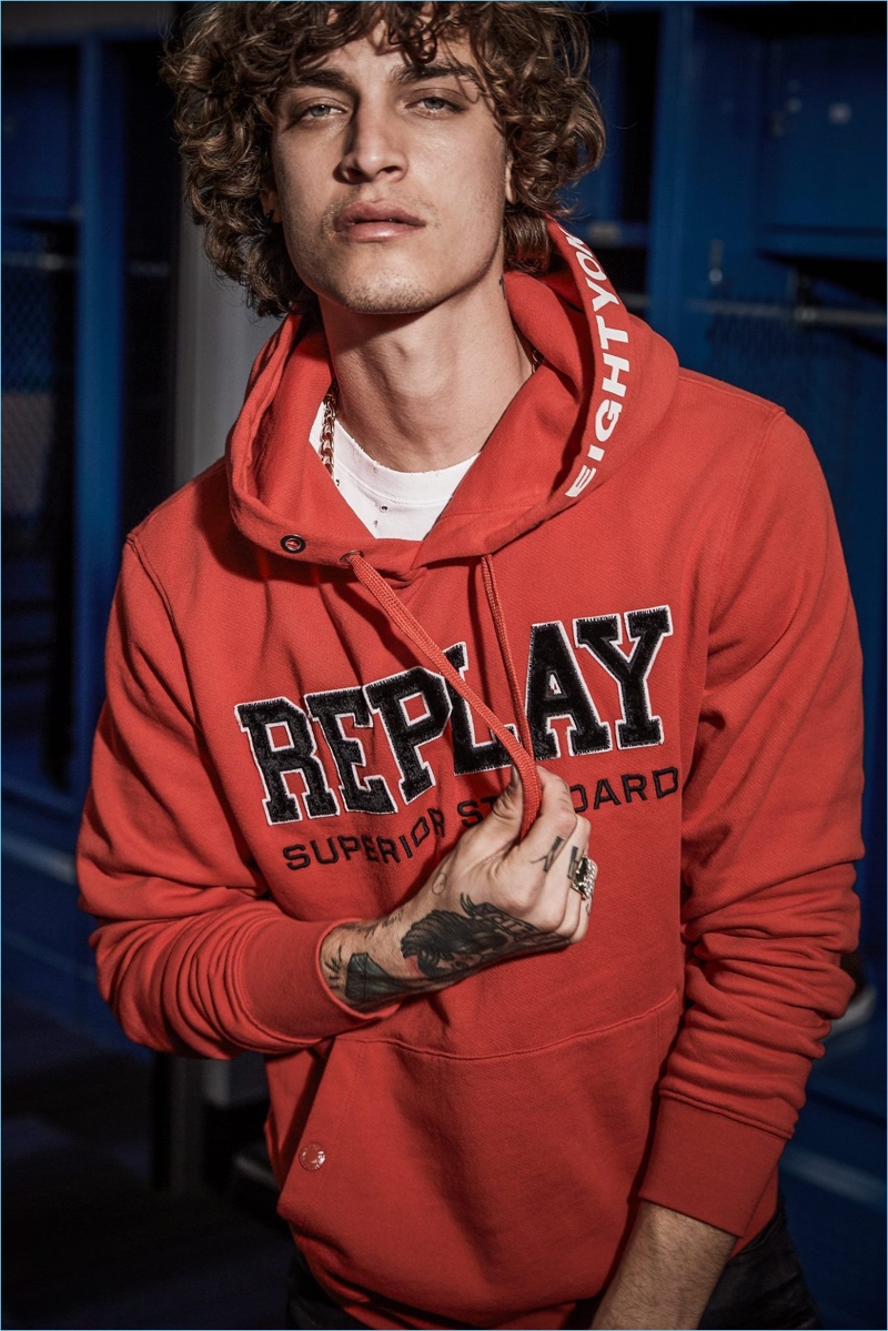 Jonathan Bellini rocks a red hoodie from Replay's fall-winter 2018 collection.