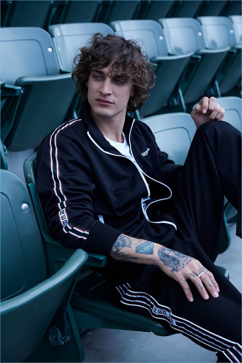 Going sporty, Jonathan Bellini wears a tracksuit from Replay.
