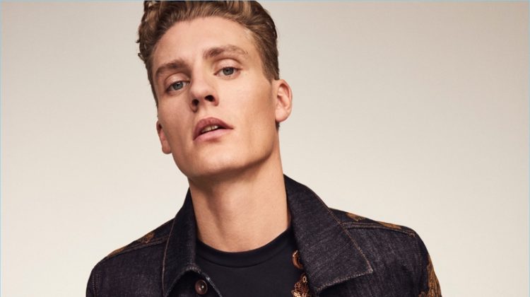 Front and center, Mikkel Jensen rocks an embroidered denim jacket and t-shirt with jeans from River Island's RI30 collection.