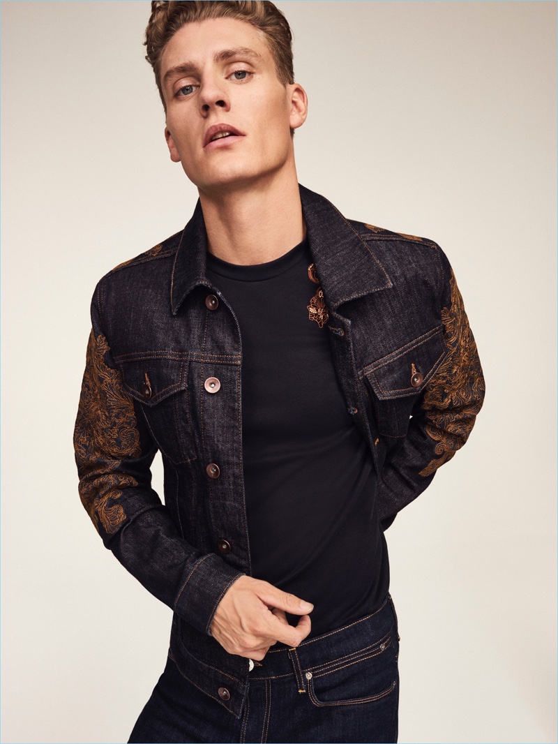 Front and center, Mikkel Jensen rocks an embroidered denim jacket and t-shirt with jeans from River Island's RI30 collection.