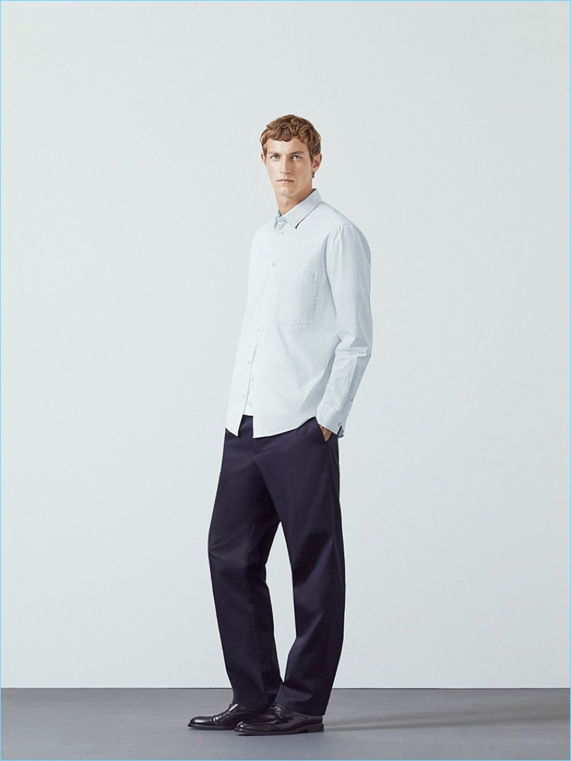 Dutch model Rutger Schoone sports straight-leg chinos and a cotton shirt by COS.