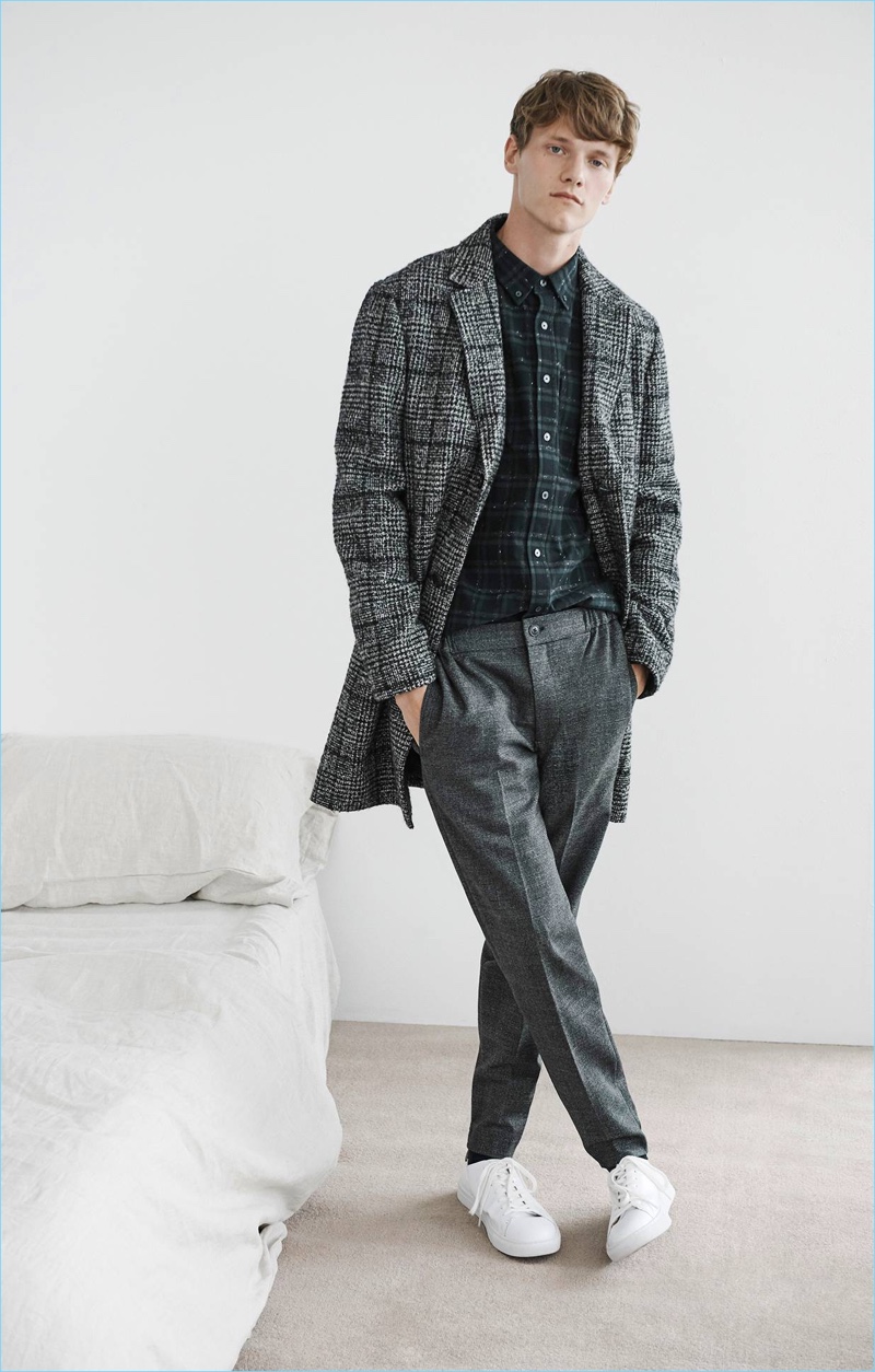 Dressed for fall, Ryan Keating sports a Club Monaco plaid shirt, textured topcoat, and Glen plaid pants.