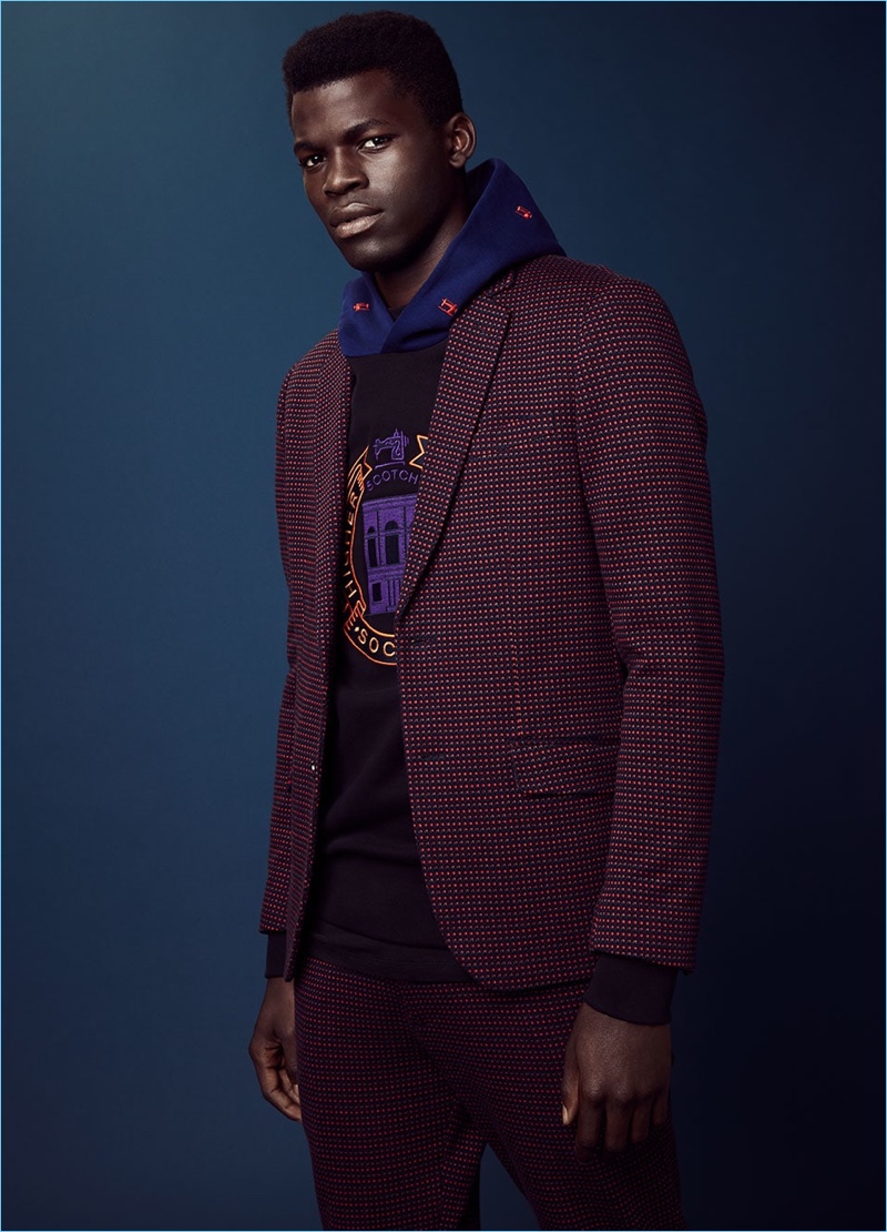Evandro Laurens dons a checked blazer and trousers with an embroidered hoodie from Scotch & Soda.