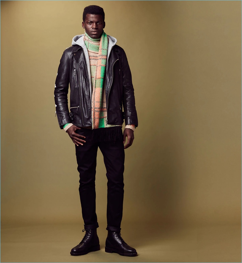 Front and center, Evandro Laurens wears a Scotch & Soda hoodie with a tartan sweater and scarf.