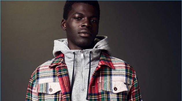 Two-Piece Expeditions: Evandro Laurens Rocks Prints for Scotch & Soda Model Evandro Laurens sports a hoodie with a tartan trucker jacket and trousers by Scotch & Soda.
