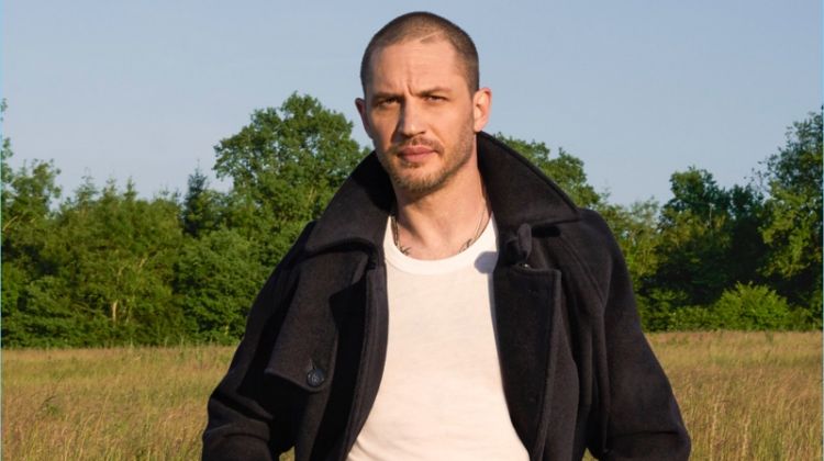 Actor Tom Hardy dons a coat and trousers by Giorgio Armani with an Armani Exchange t-shirt.