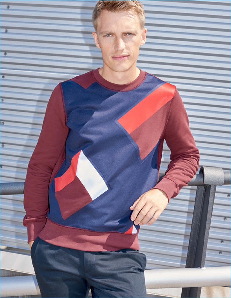 Model Victor Nylander wears a geometric print Burberry sweatshirt.