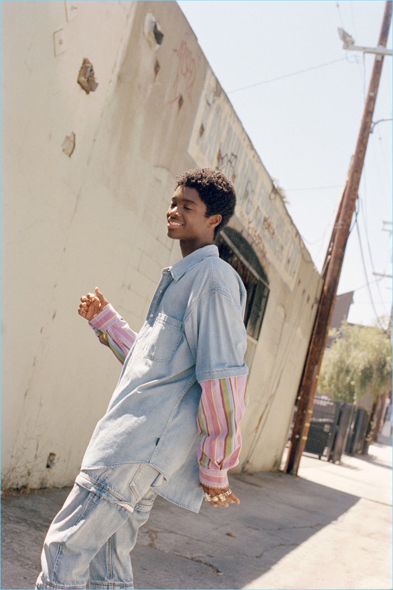 On the move, Alton Mason sports a shirt and jeans from Balenciaga.