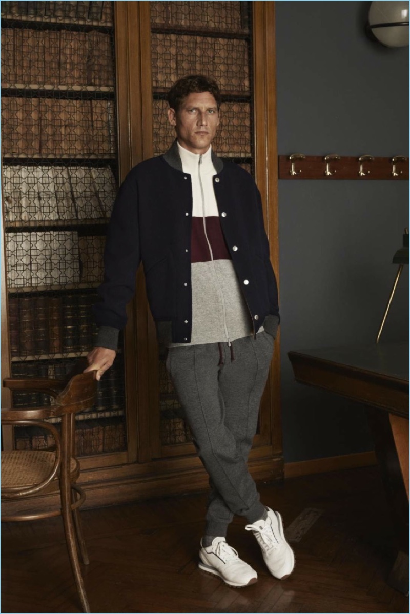 Layering for fall, Roch Barbot sports a bomber jacket, fill-zip sweater, and joggers from Brunello Cucinelli.