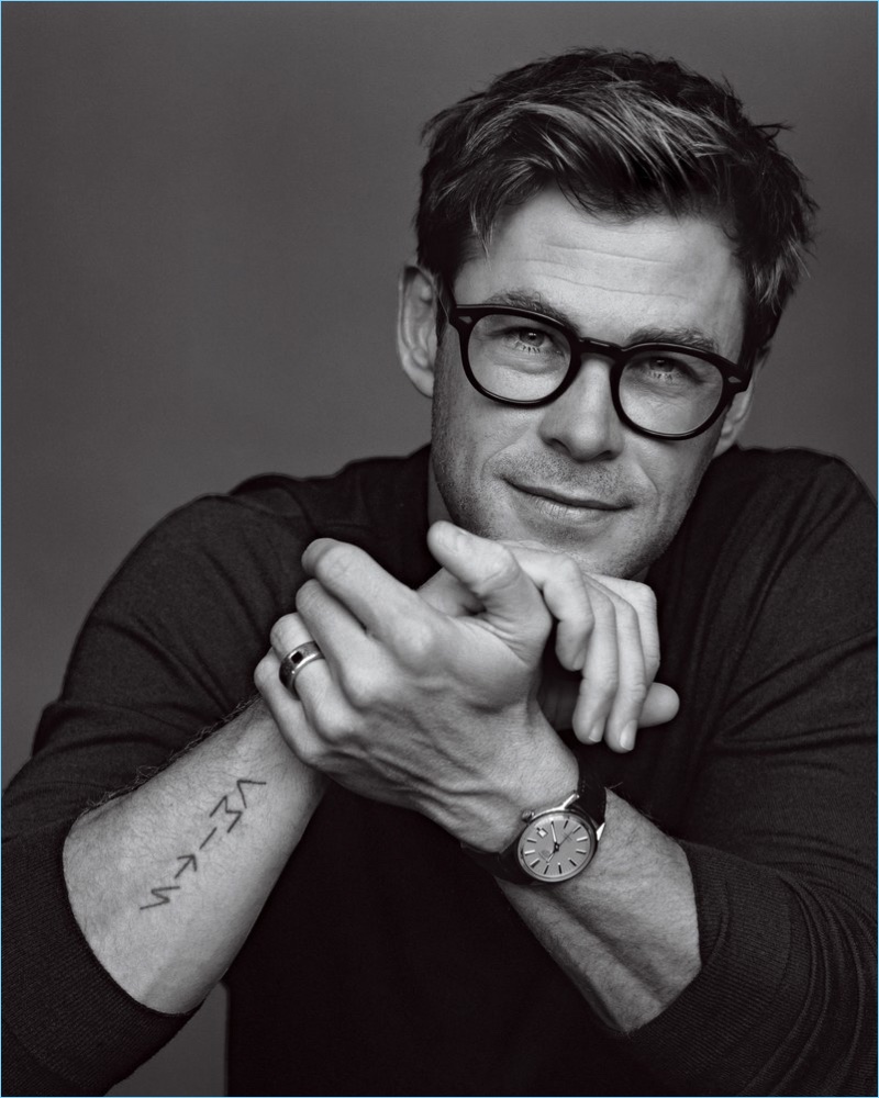 A smart vision, Chris Hemsworth dons Moscot glasses with a Gucci sweater and TAG Heuer watch.