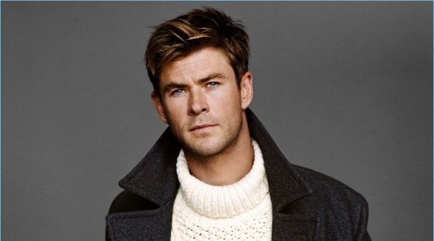 Appearing in a new photo shoot, Chris Hemsworth wears a BOSS coat, and Michael Kors sweater. He also dons a Tom Ford leather belt and pants.