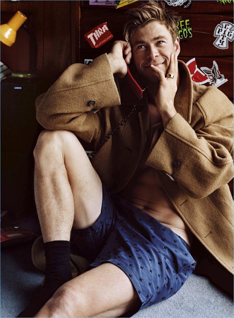Actor Chris Hemsworth wears a Dries Van Noten coat with Stella McCartney swim shorts.