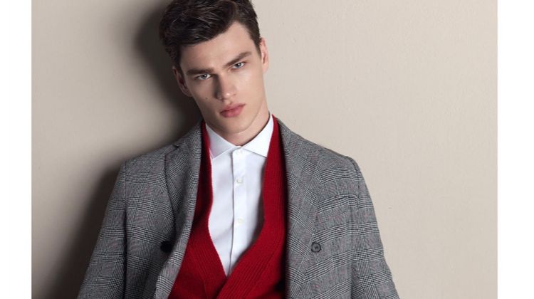 Model Filip Hrivnak wears a red cardigan with a grey suit for Gazzarrini's fall-winter 2018 campaign.
