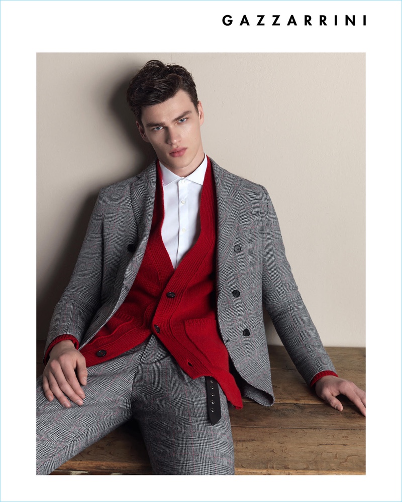 Model Filip Hrivnak wears a red cardigan with a grey suit for Gazzarrini's fall-winter 2018 campaign.