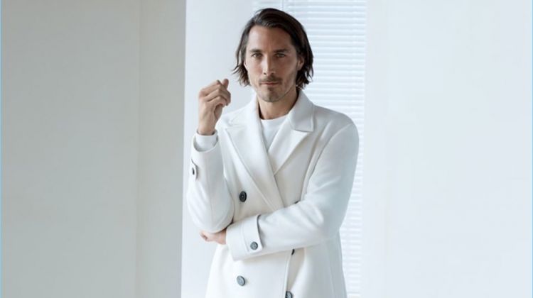 Sporting winter white, Guillaume Macé appears in an editorial for Zara.