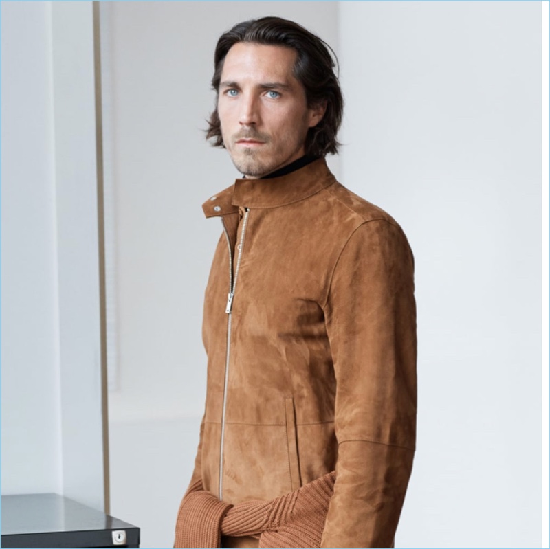 Guillaume Macé sports a brown suede jacket by Zara.