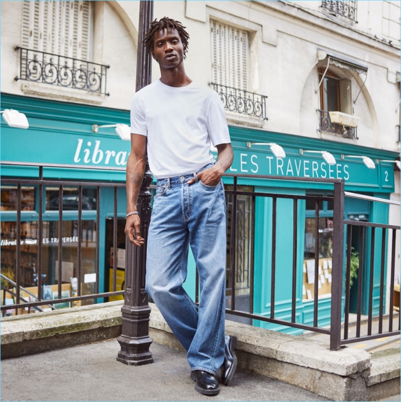 Tapping into 90s style, Adonis Bosso sports a H&M tee with baggy jeans.