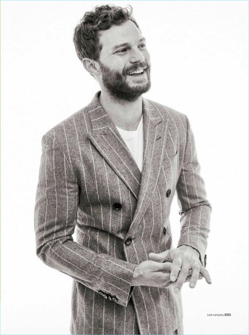 All smiles, Jamie Dornan wears a double-breasted pinstripe suit by BOSS.