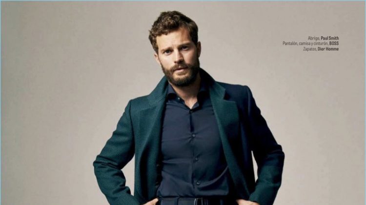 Embracing fall style, Jamie Dornan wears a Paul Smith coat with a shirt, belt, and pants by BOSS. Dior Men shoes complete his look.