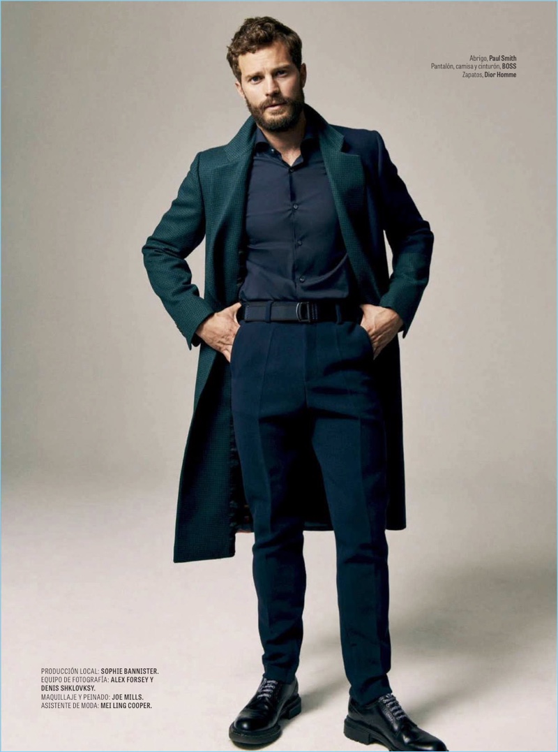 Embracing fall style, Jamie Dornan wears a Paul Smith coat with a shirt, belt, and pants by BOSS. Dior Men shoes complete his look.