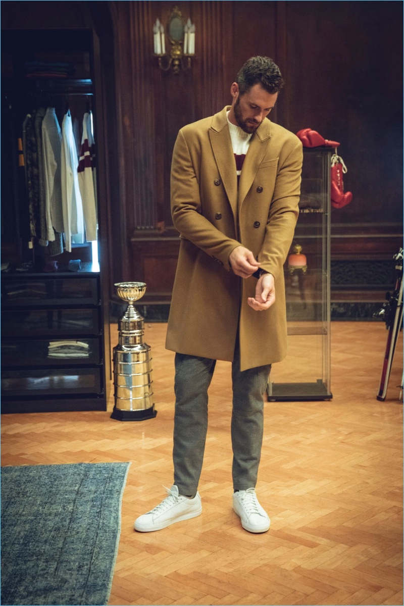 Embracing varsity style, Kevin Love dons a double-breasted topcoat, stripe sweater, and wool track pants from his Banana Republic collaboration.