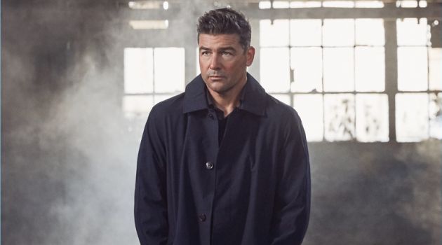 Kyle Chandler Covers Modern Luxury, Talks 'Catch-22' Starring in a photo shoot, Kyle Chandler wears a Michael Kors coat with a shirt nd trousers by Ermenegildo Zegna.