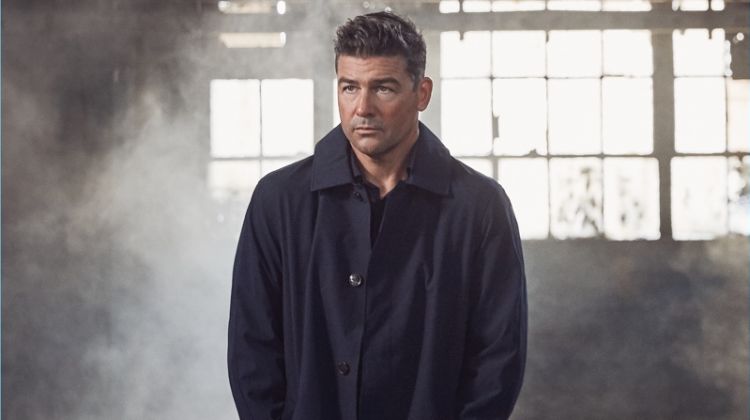Starring in a photo shoot, Kyle Chandler wears a Michael Kors coat with a shirt nd trousers by Ermenegildo Zegna.