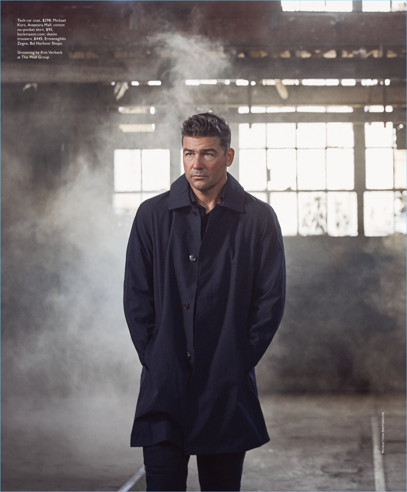 Starring in a photo shoot, Kyle Chandler wears a Michael Kors coat with a shirt nd trousers by Ermenegildo Zegna.