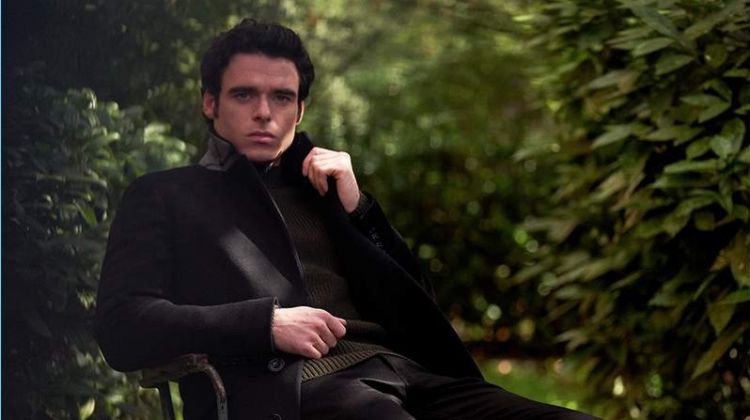 Venturing outdoors, Richard Madden sports a Burberry coat, Mr P. sweater, and Acne Studios jeans.
