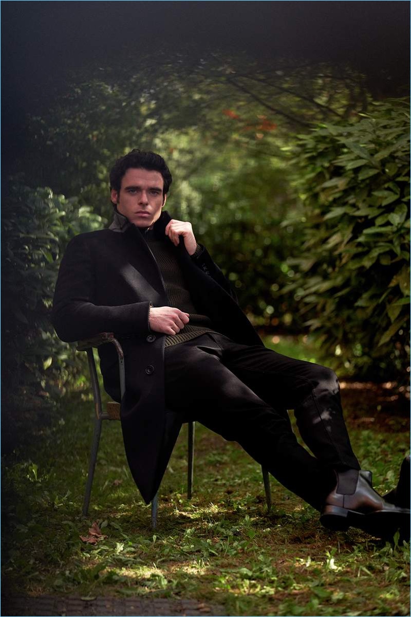 Venturing outdoors, Richard Madden sports a Burberry coat, Mr P. sweater, and Acne Studios jeans.